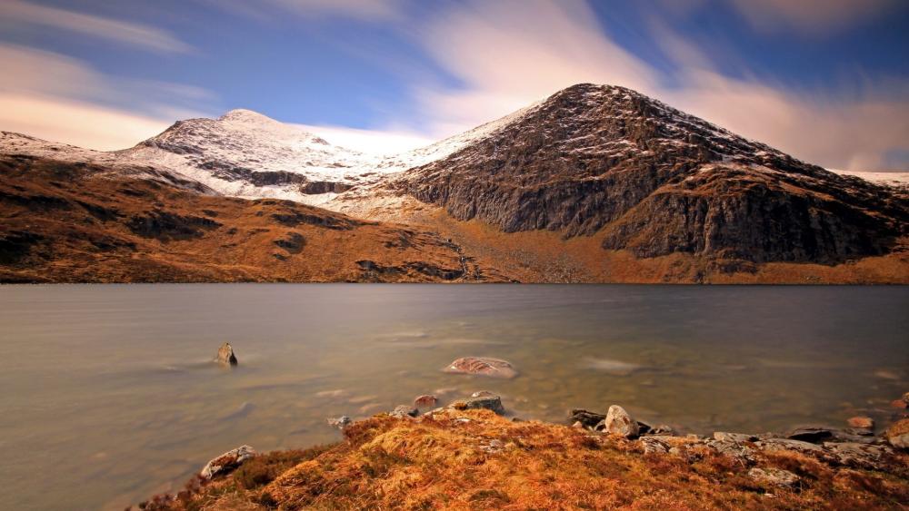 Serene Mountain Landscape with Tranquil River wallpaper
