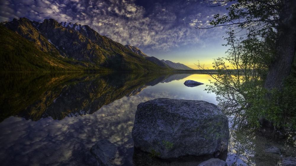 Serene Lake Reflection with Boulder and Mountains wallpaper
