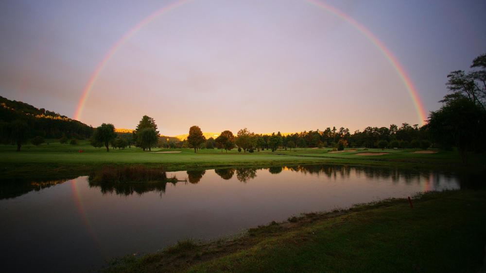 Rainbow over Tranquil Waters at Dusk wallpaper