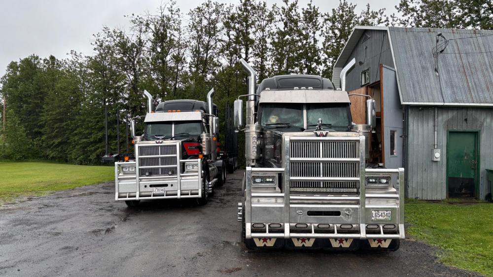 Powerful Trucks Lined Up in Rustic Setting wallpaper
