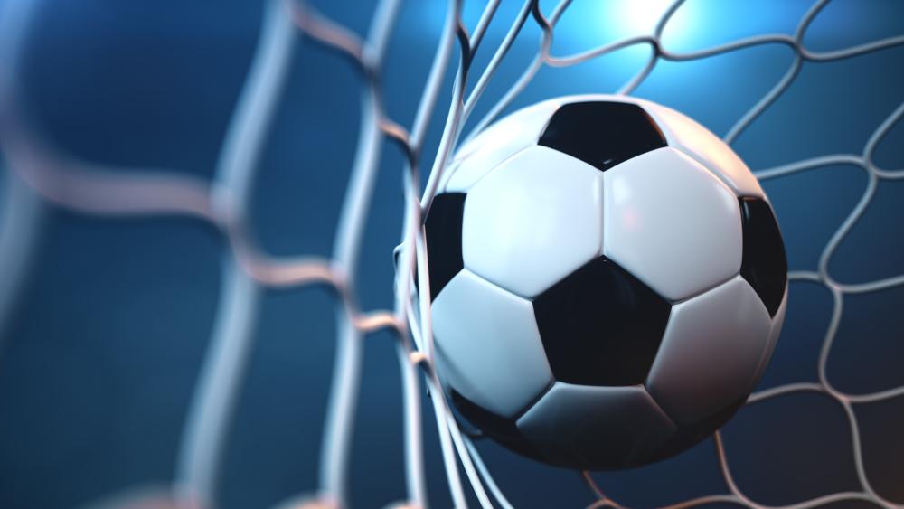 Dynamic Soccer Ball Striking the Goal Net wallpaper