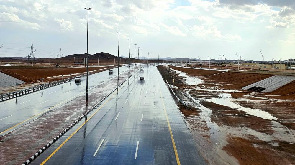 Wet Highway Through Desert Landscapes wallpaper