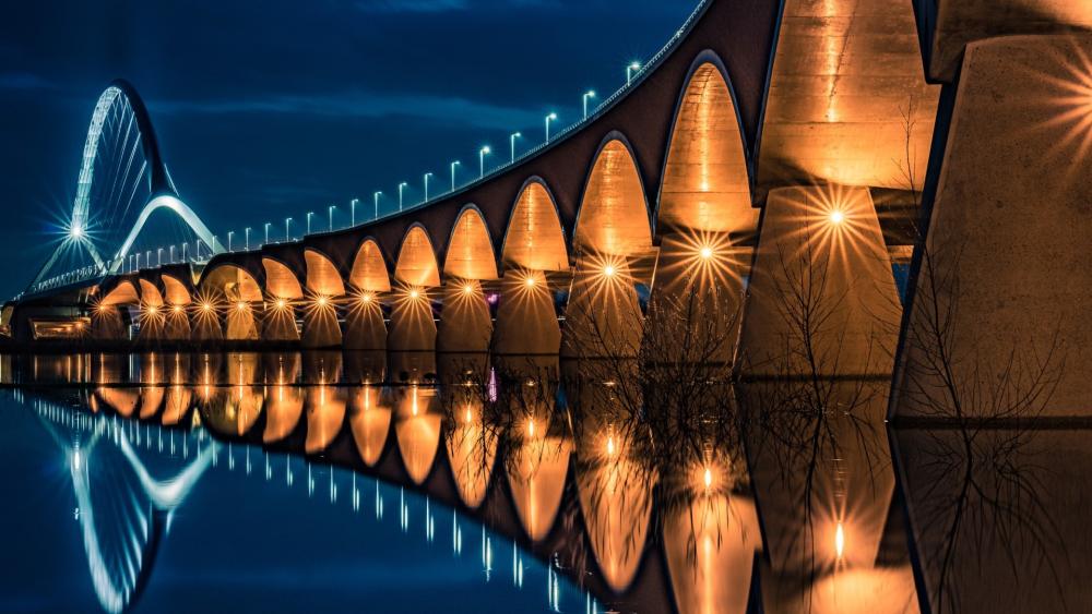 De Oversteek's Nighttime Glow over Waal River wallpaper