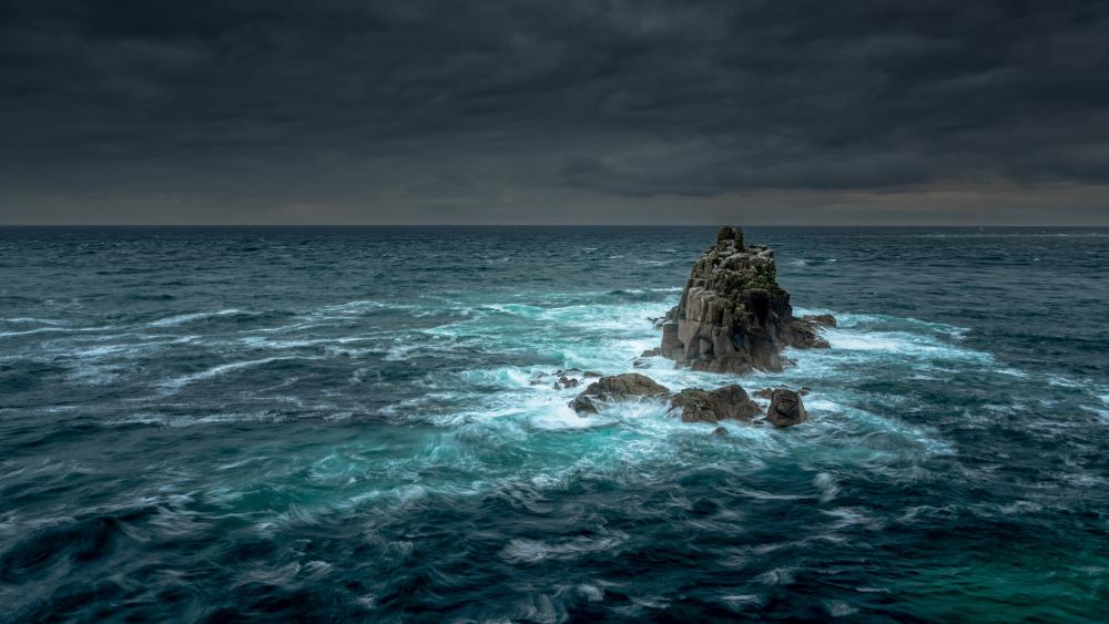 Stormy Sea Surrounding Rocky Outcrop in Stunning 4K Clarity wallpaper