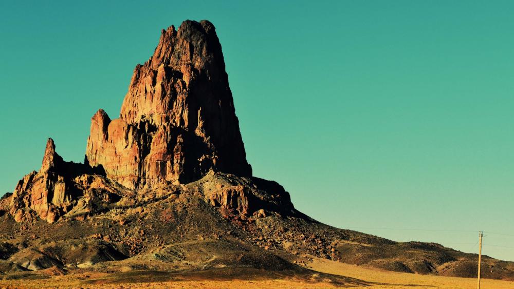 Majestic Desert Butte Under Clear Skies wallpaper