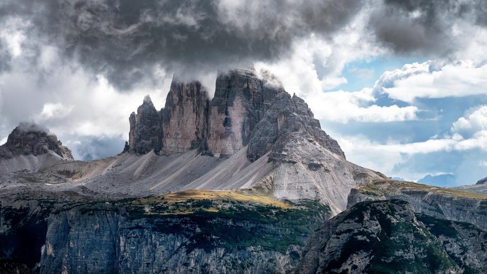 Majestic Dolomite Peaks Under Dramatic Clouds wallpaper