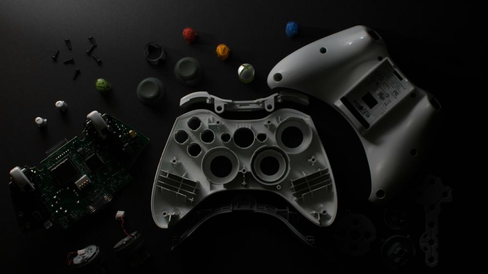 Xbox Controller Disassembled on Black Background wallpaper