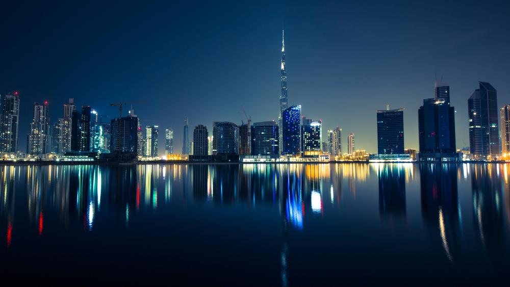 Dubai's Glittering Nighttime Horizon in Blue wallpaper