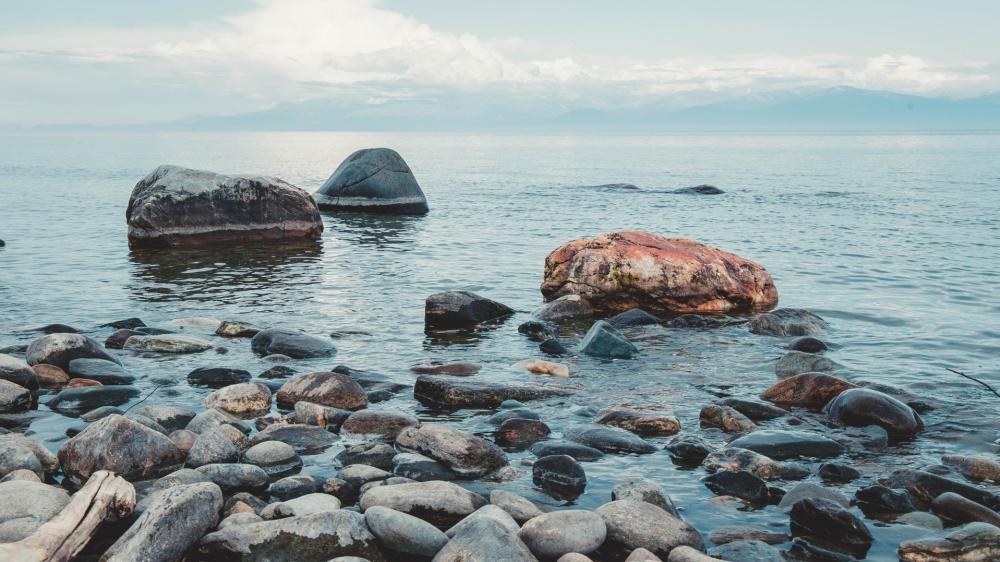 Boulders by Tranquil Waterscape wallpaper