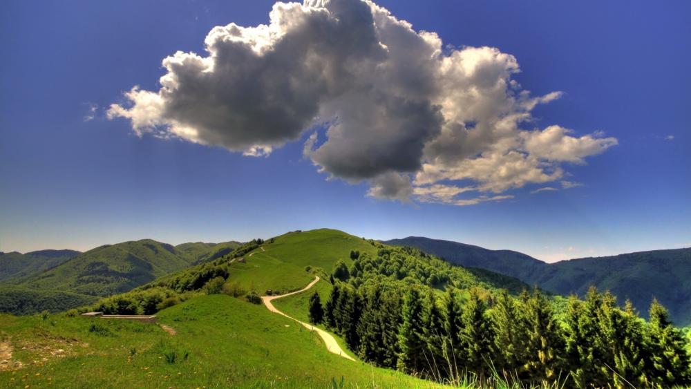 Rolling Hills Under Majestic Clouds wallpaper