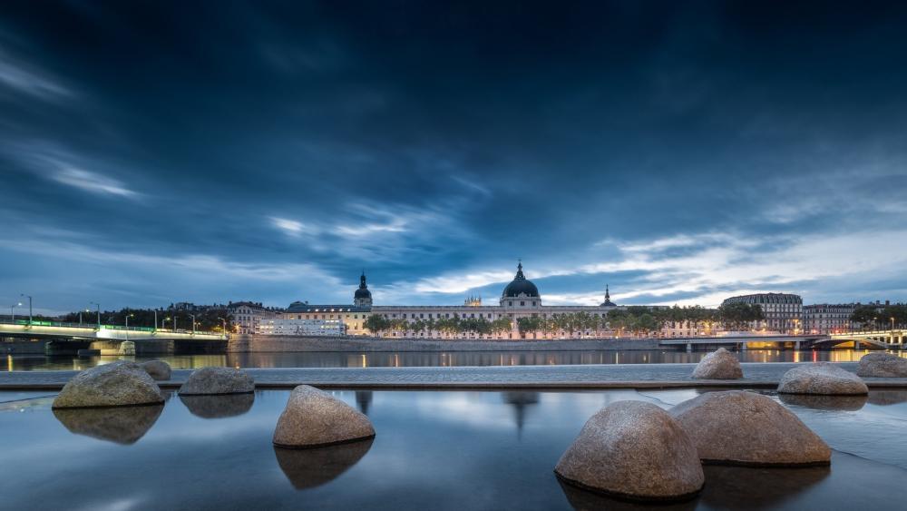 Hôtel-Dieu de Lyon Against a Dramatic Evening Sky wallpaper