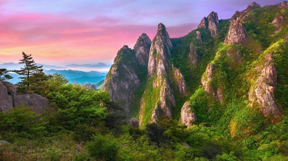Majestic Peaks Glow Under Vibrant Sunset Sky wallpaper