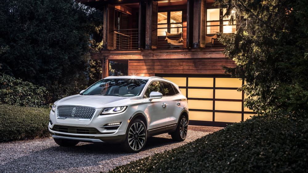 Sleek SUV at a Stylish Modern Home wallpaper