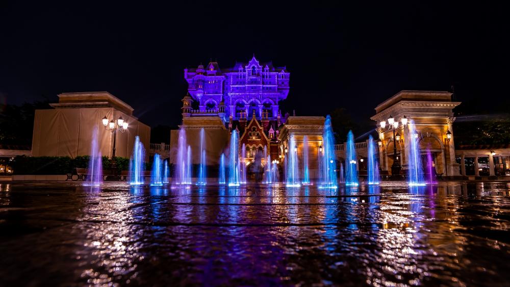 Vibrant Fountain Display Amidst Tokyo DisneySea Nightscape wallpaper