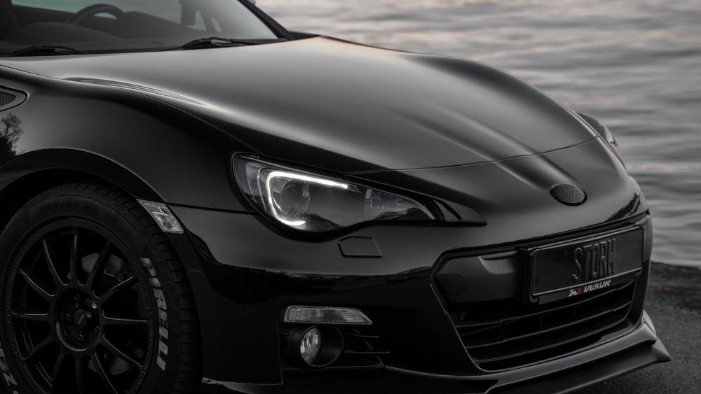 Sleek Black Beauty on the Shoreline wallpaper