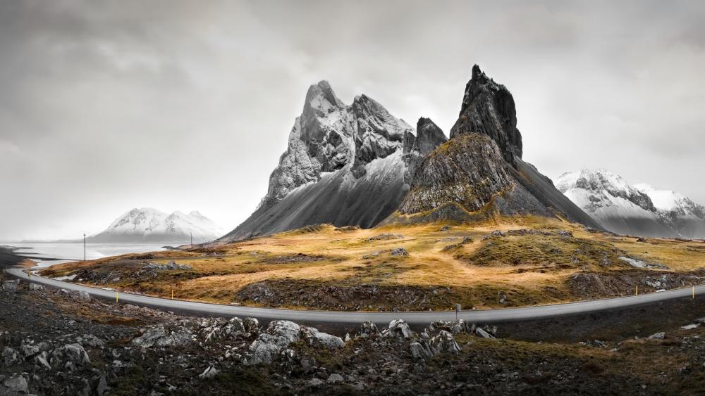 Majestic Peaks Under Stormy Skies in Eystrahorn wallpaper