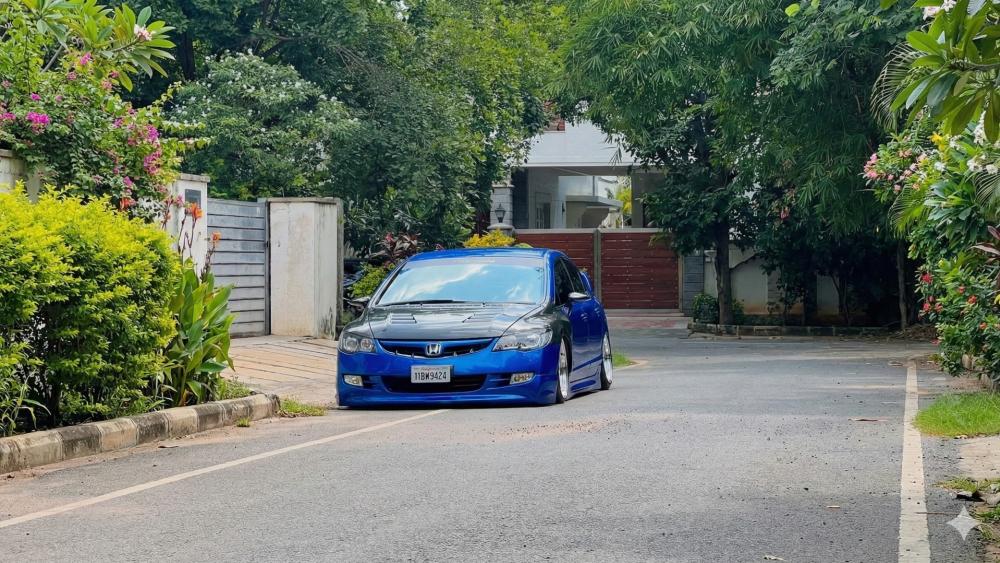 Sleek Blue Honda on Serene Street Scene wallpaper
