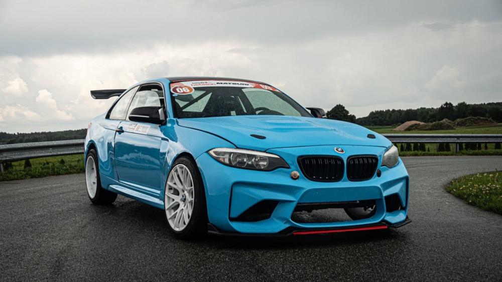 Sleek Blue BMW on a Wet Track wallpaper