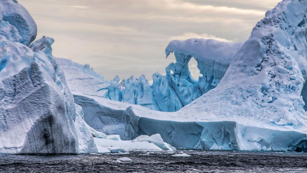 Frozen Iceberg Cathedral on Antarctic Waters in Crisp 4K wallpaper
