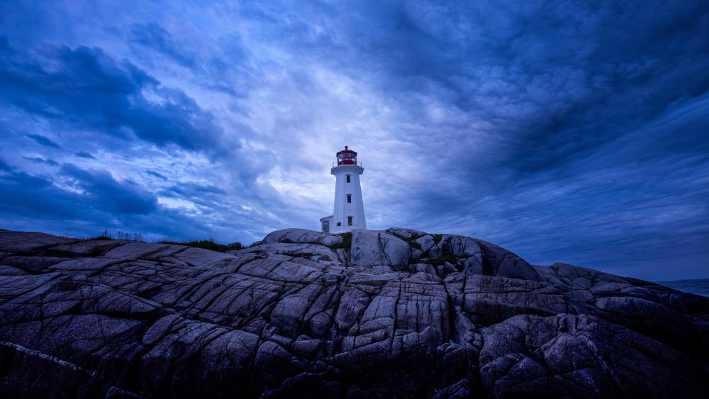 Peggy's Cove Lighthouse Beneath Dramatic Dusk Skies in Nova Scotia wallpaper
