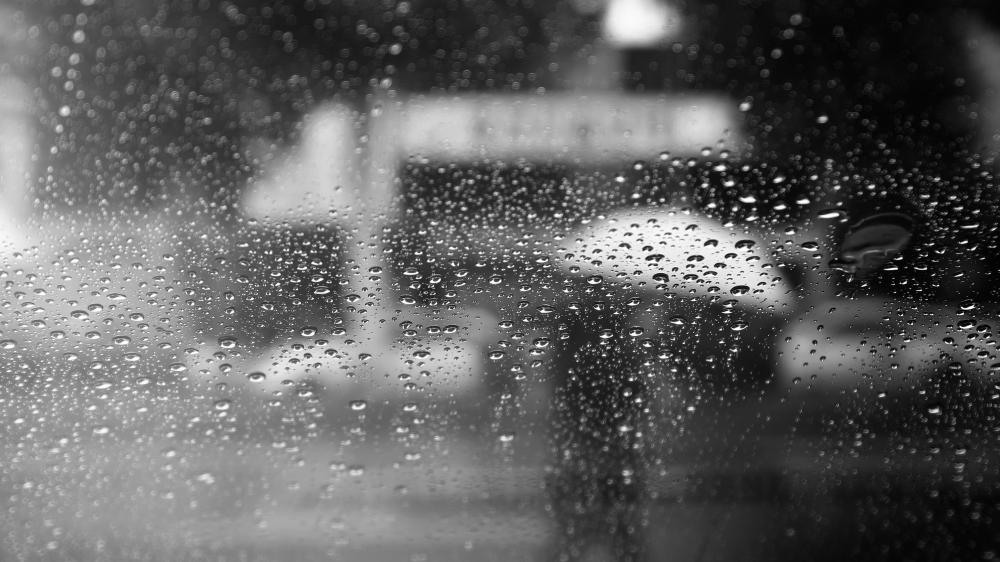 Monochrome Rain Drops on Glass in Soft Urban Blur wallpaper