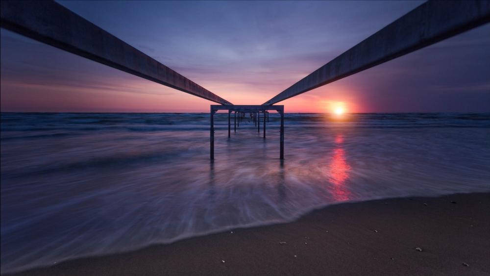 Sunset Afterglow Over Restless Sea and Quiet Sandy Beach wallpaper