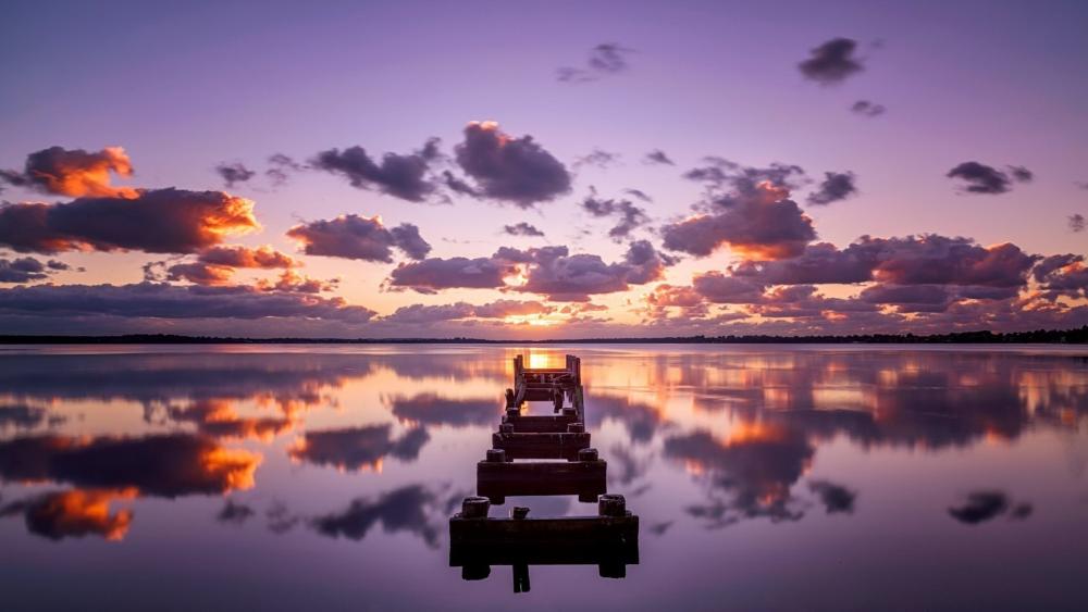 Purple Twilight Over a Tranquil Mirror Lake and Quiet Dock wallpaper