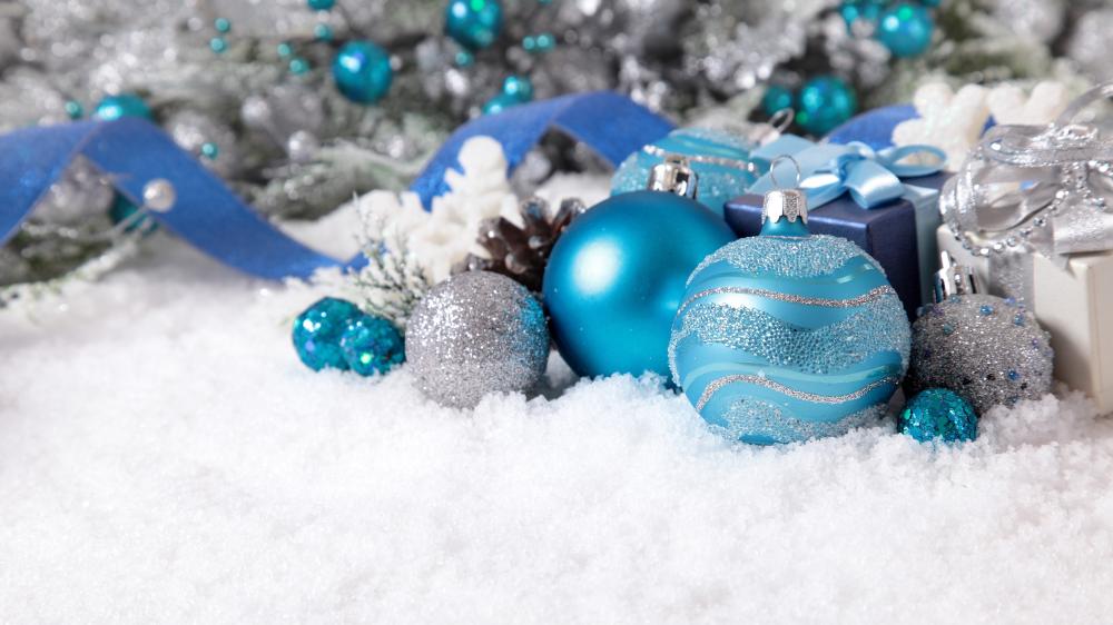 Blue and Silver Christmas Ornaments Resting on Fresh Snow wallpaper