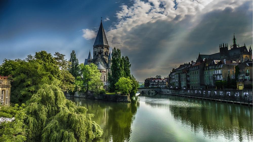 Temple Neuf Spire Over Strasbourg Canal Under Dramatic Skies wallpaper