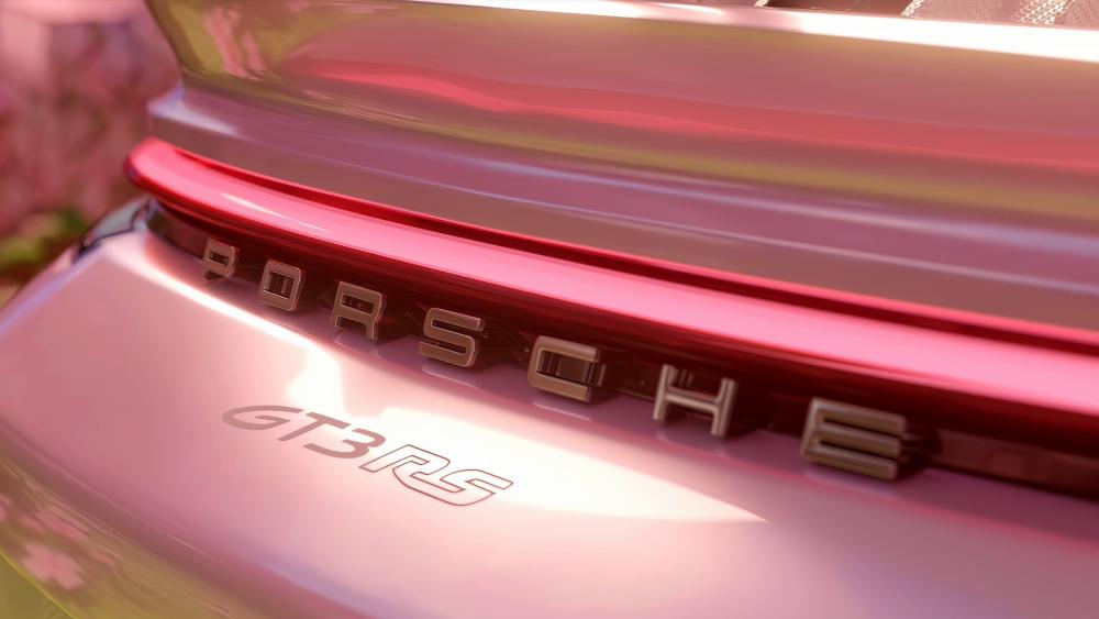 Sunlit Porsche GT3 RS Badge in Glossy Red Close Up wallpaper