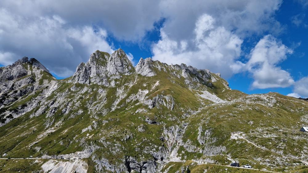 Rugged Mangart Peaks Under Summer Clouds in the Julian Alps wallpaper