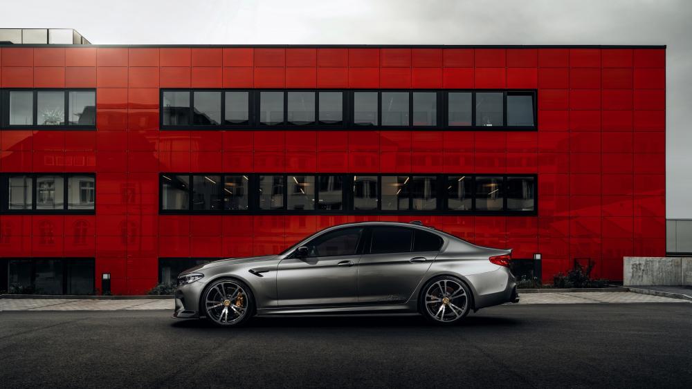 BMW M5 Side Profile Against Bold Red Modern Architecture wallpaper