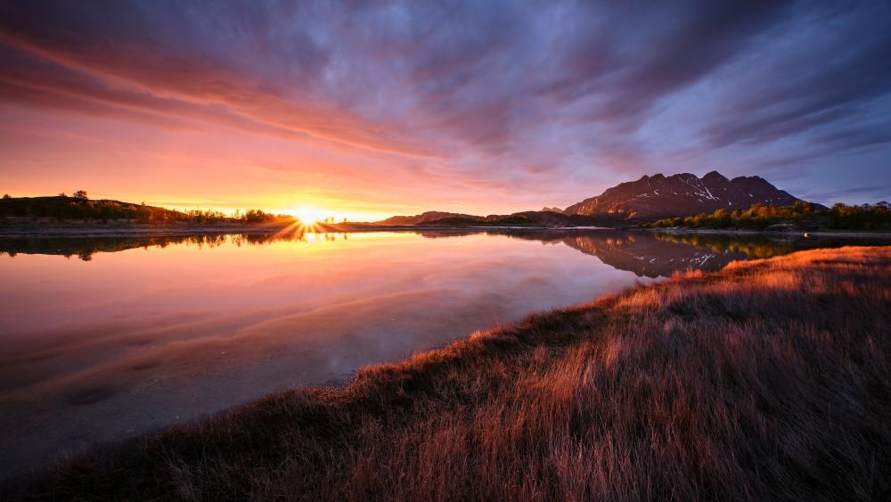 Midnight Sun Sunset Over Mirror Lake and Mountain Horizon wallpaper