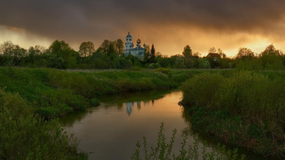 Golden Evening Over Riverside Temple and Silent Meadow Canal wallpaper