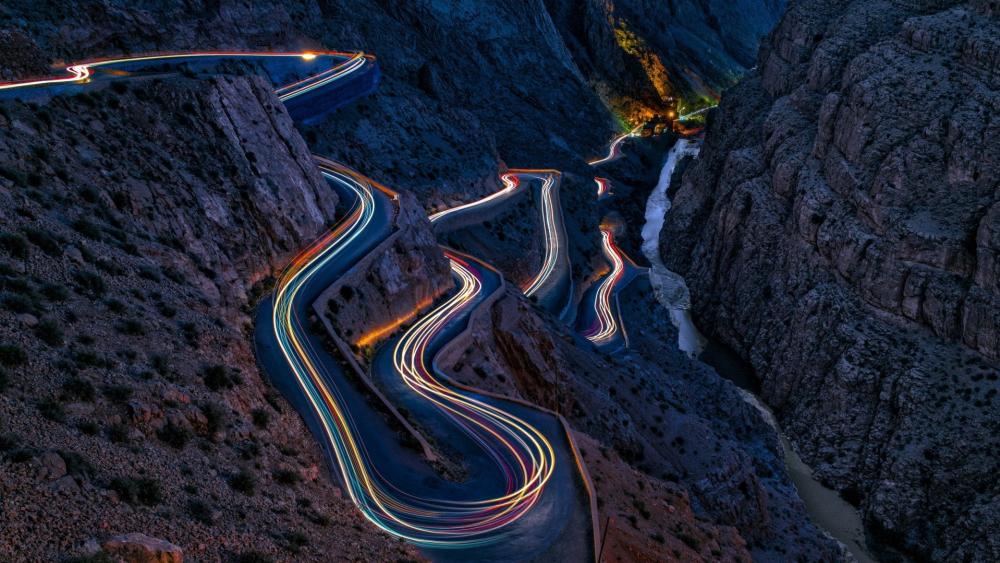 Serpentine Light Trails Through Dades Gorges at Dusk Morocco wallpaper