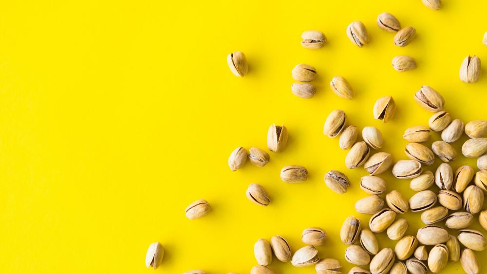 Pistachio Scatter on Vibrant Yellow Minimal Foodie 4K Wallpaper wallpaper
