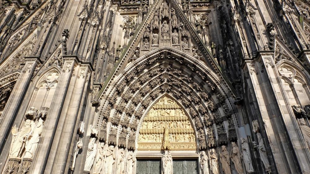 Gothic Grandeur at Cologne Cathedral Facade and Sacred Arch wallpaper