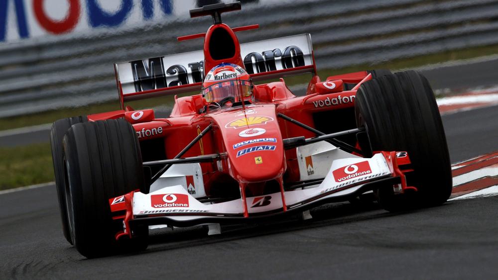Scuderia Ferrari Formula 1 Machine Charging Through a Fast Corner wallpaper