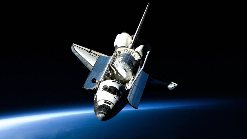 Space Shuttle Orbiter Gliding Above Earths Blue Horizon wallpaper