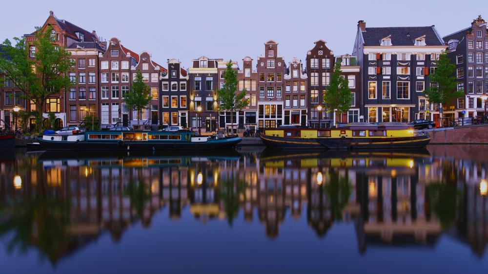 Twilight Reflections Along Amsterdam Canal Houses in the Netherlands wallpaper