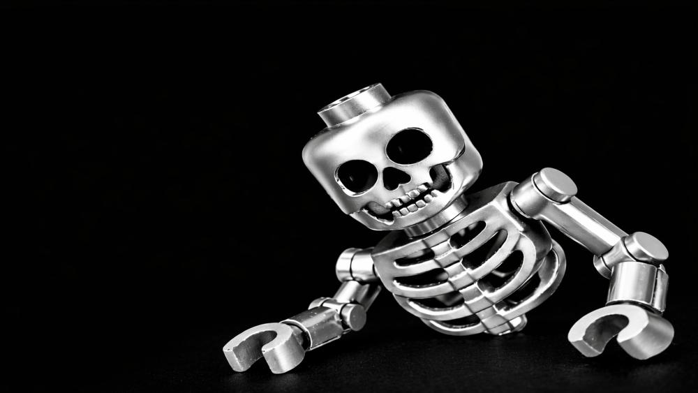 Shiny Lego Skeleton Strikes a Cheeky Pose on Deep Black wallpaper