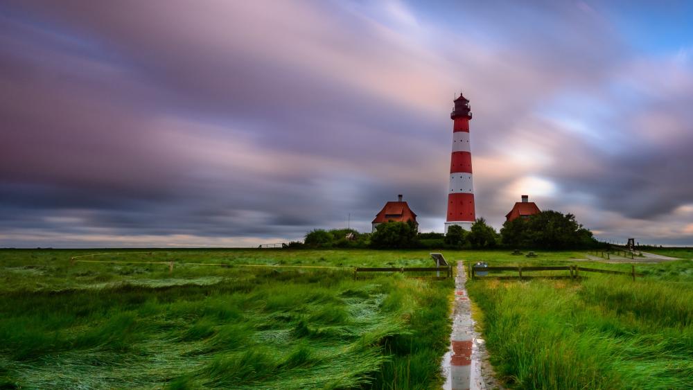 Westerheversand Lighthouse Over Windswept Grasslands in Northern Germany wallpaper