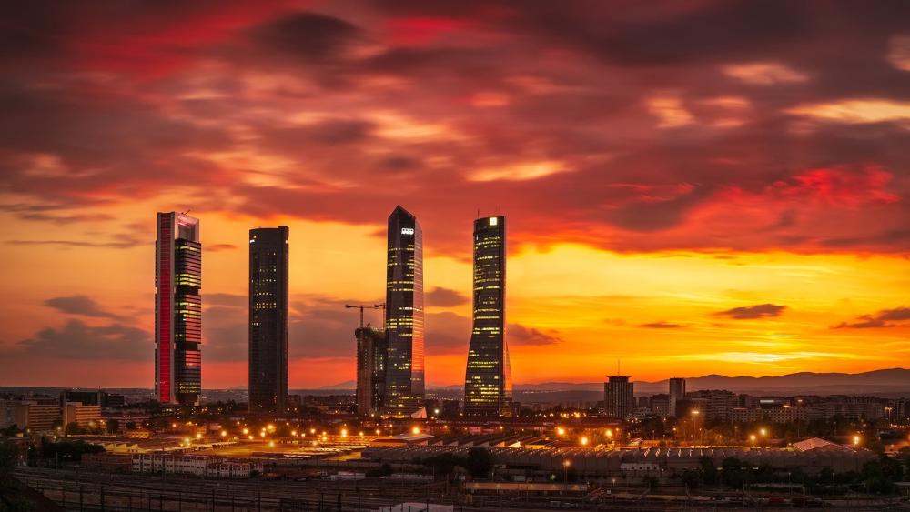 Fiery Sunset Over Madrid Cuatro Torres Skyline wallpaper