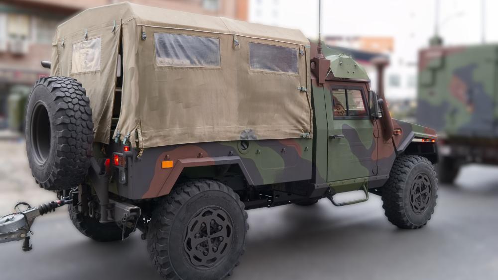 Camouflage Tactical Utility Vehicle in Urban Staging Area 5K Wallpaper wallpaper
