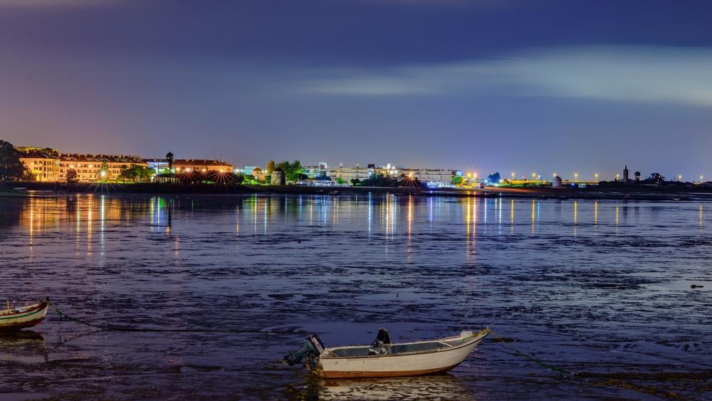 Evening Harbor Reflections with a Quiet Motorboat in the City wallpaper