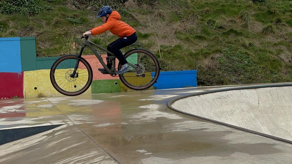 Airborne Mountain Bike Jump Over Wet Skatepark Ramp wallpaper