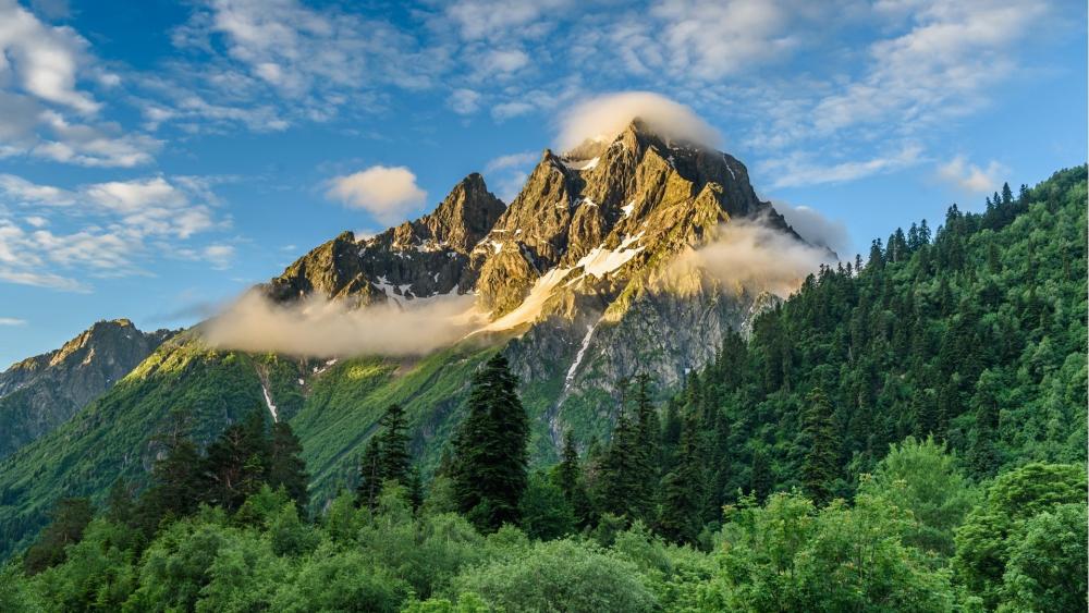 Golden Morning Clouds Over the Rugged Caucasus Mountains wallpaper