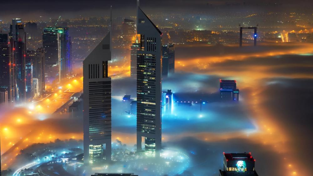 Dubai Skyscrapers Rising Above Misty Evening Fog wallpaper