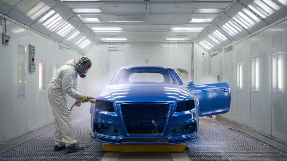 Midnight Blue Performance Car Being Painted in a Modern Spray Booth wallpaper