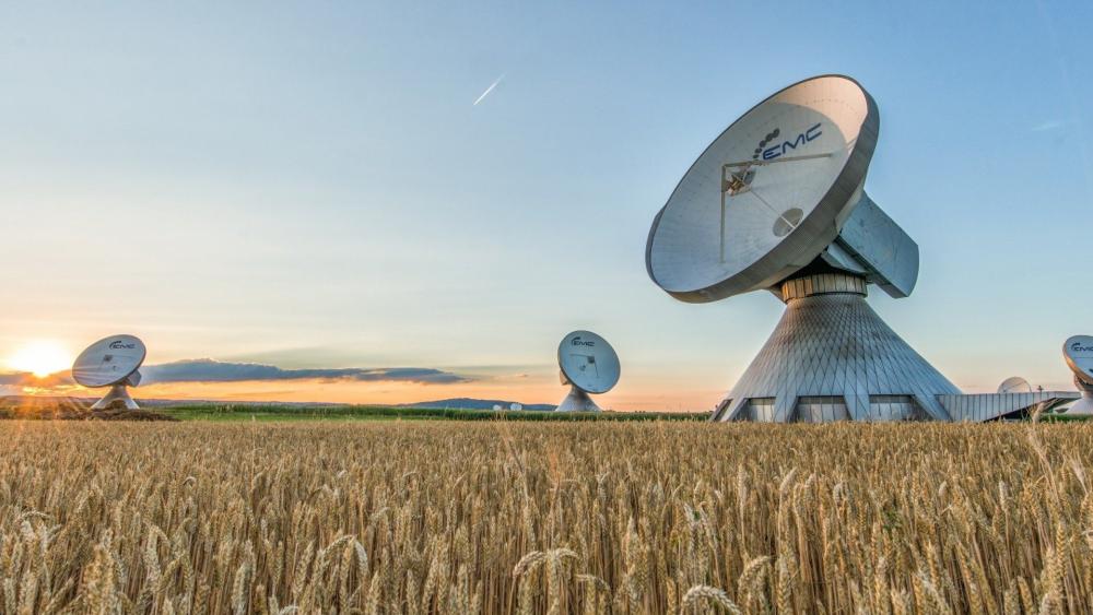 Radio Telescopes Rising Above Golden Wheat Fields at Sunset wallpaper